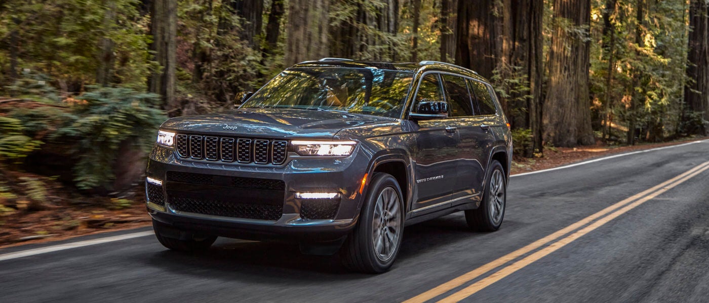 2021 Jeep Grand Cherokee L driving in woods