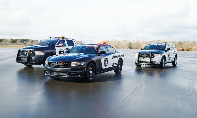 Three Dodge cop cars including Durango taking a curve