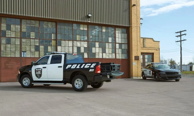 Two Police Vehicles Parked By Building